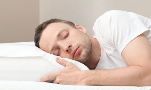 Portrait of sleeping Young Caucasian man in white